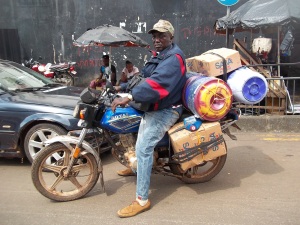 Rev Williams load his motorcycle to carry supplies to Shenge